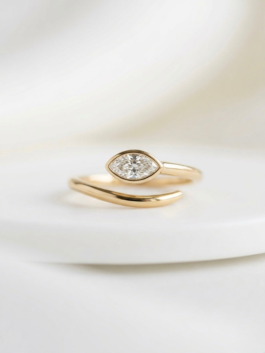 Gold ring with a diamond on a light background