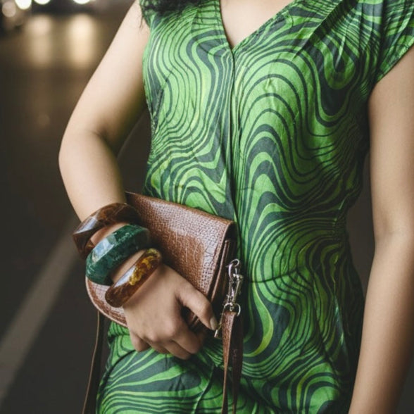 Woman in party outfit accessorized with statement bangles